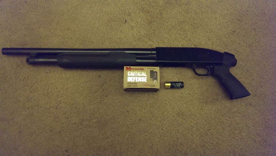 Mossberg shotgun with box of Critical Defense shells and one loose shell