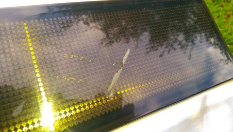 1996 Ford Bronco - Close-up of a rear tailgate applique with a diamond pattern and yellow lighting elements.