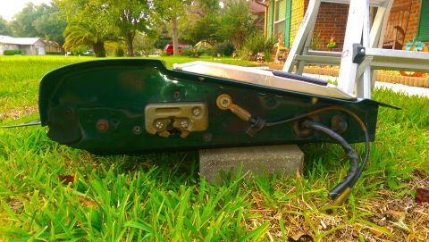 1996 Ford Bronco - Close-up of a green tailgate latch mechanism, showing the internal workings and attached wiring.