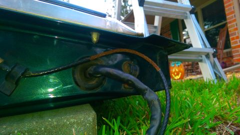 1996 Ford Bronco - Green vehicle part with wiring harness and a brown wire bundle visible.