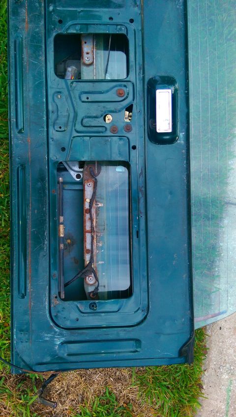 1996 Ford Bronco - The interior of a Ford Bronco tailgate is visible, with its internal mechanisms exposed.