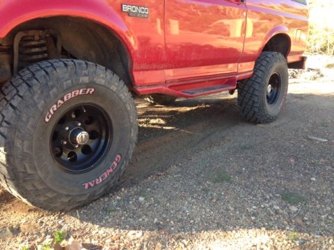 1996 Ford Bronco - Side view of a red 1996 Ford Bronco, equipped with General Grabber off-road tires.