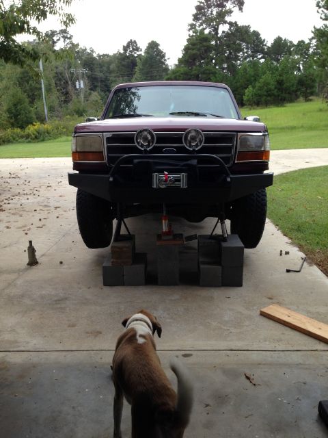 1996 Ford Bronco - Front view of a 1996 Ford Bronco being worked on, an aftermarket bumper and winch.