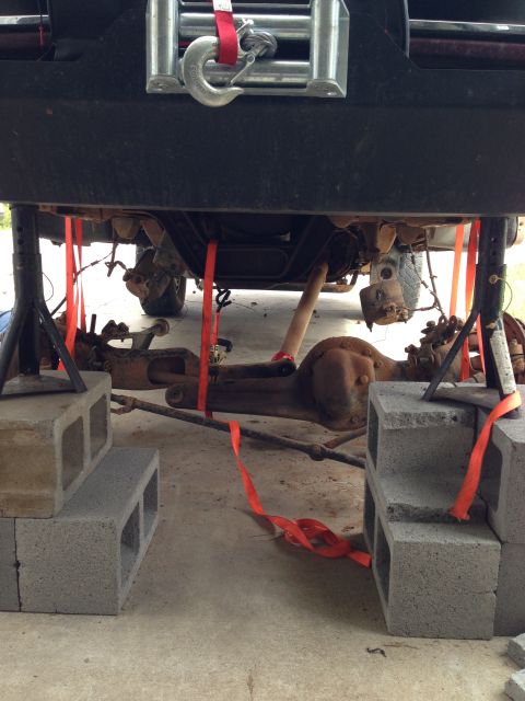 1996 Ford Bronco - The rear axle and suspension of a 1996 Ford Bronco are secured with straps and blocks for maintenance.