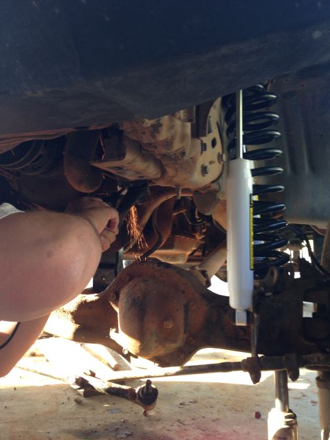 1996 Ford Bronco - Working on the suspension system of a vehicle, sparks flying from grinding.