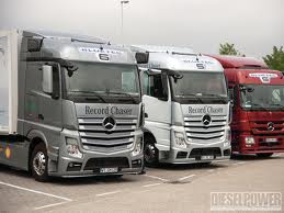 2000 Ford 427 - A lineup of Mercedes-Benz trucks, with prominent branding and model details visible on the front grilles.
