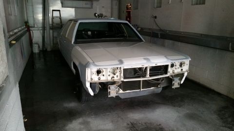 1991 Ford LTD Crown Victoria - A white 1991 Ford Crown Victoria is parked in a garage with its front bumper and grille removed.