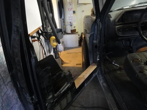 1988 Ford Bronco - Interior view of a 1988 Ford Bronco showing disassembled door panel and worn seat.