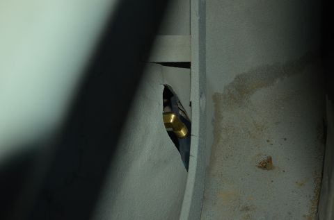 1979 Ford Bronco - A close-up view shows a brass fitting connected to a propane tank, likely installed in a vehicle.