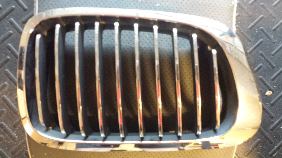 Chrome and black car grille with vertical slats