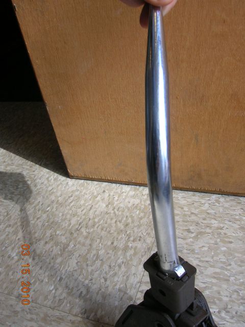 1968 Ford Torino - A chrome shift knob and lever assembly is shown against a wooden background.