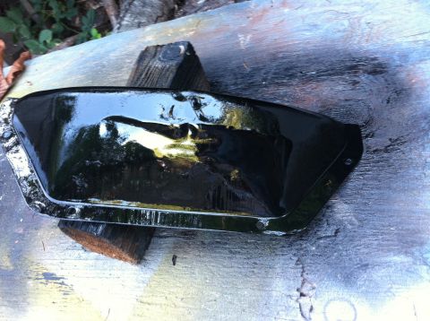 1968 Ford Torino - A freshly painted black oil pan sits on wooden blocks outdoors, with a Supermotors logo visible.