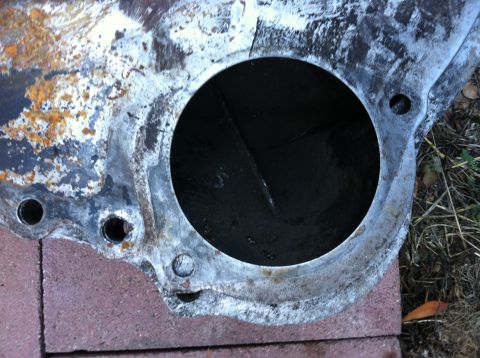 1968 Ford Torino - This is a close-up view of a rusty engine block part, likely from an older vehicle.