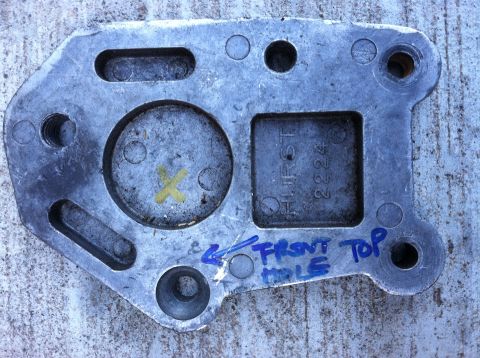 1968 Ford Torino - A metal part with stamped and handwritten labels is shown against a textured surface.