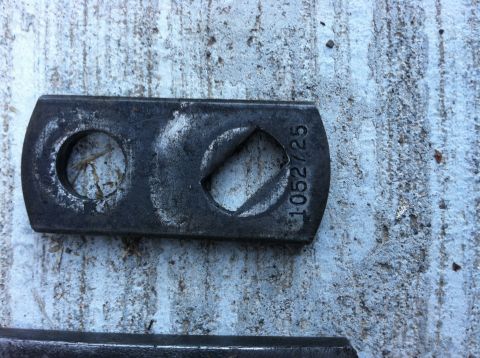 1968 Ford Torino - A metal part with stamped numbers rests on a textured surface.