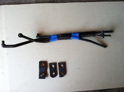 1968 Ford Torino - Automotive linkage parts are laid out on a flat surface, with blue tape securing sections of the metal rods.