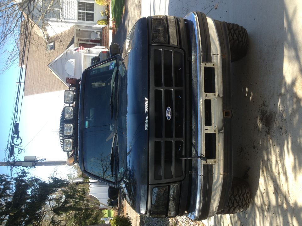 Black 1996 Ford Bronco front view with aftermarket bumper and roof lights
