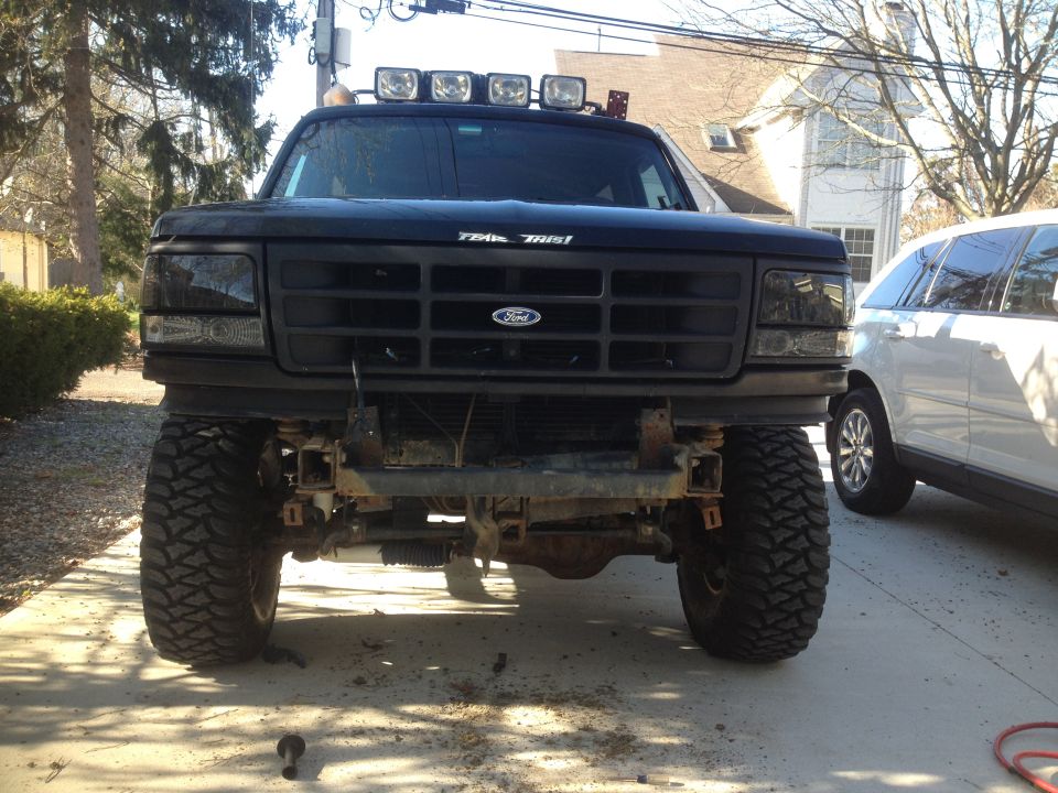 Black 1996 Ford Bronco front view with aftermarket bumper and roof lights