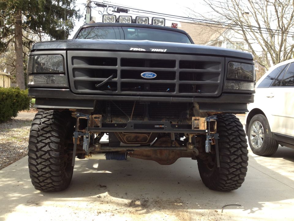 Black Ford Bronco with aftermarket winch bumper and large tires