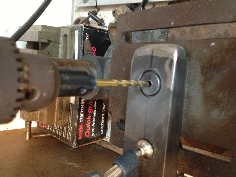 1996 Ford Bronco - A drill bit is shown entering a metal part, with visible text from a Sears Craftsman box in the background.