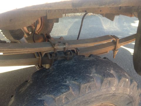 1971 Ford F-250 - Rear suspension components and tire of a truck are visible in this close-up shot.
