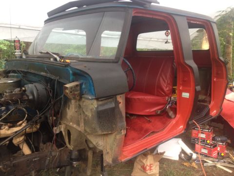 1971 Ford F-250 - This 1971 Ford F-250 shows its red interior and empty engine bay with doors open.