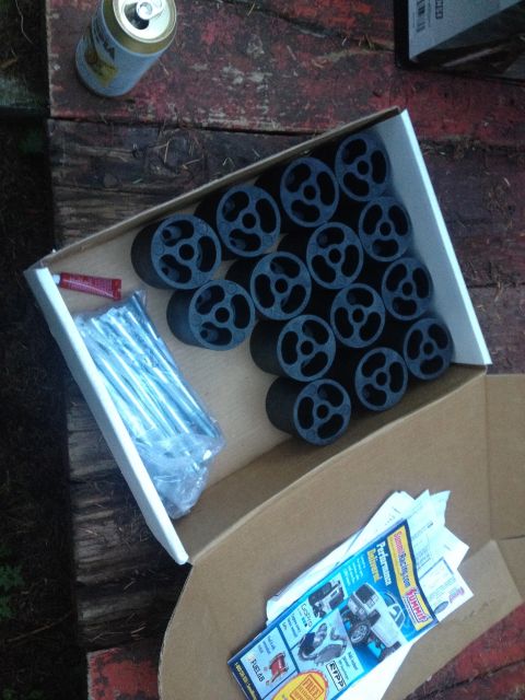 1971 Ford F-250 - A box contains lift kit components and hardware, alongside a can and some promotional flyers.