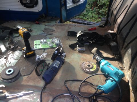 1971 Ford F-250 - Tools are spread across the floor of a vehicle's interior, suggesting ongoing work or repairs.
