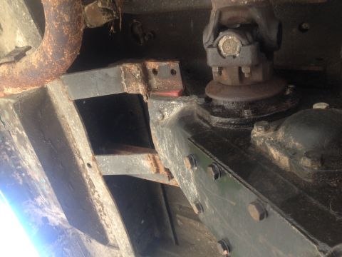 1971 Ford F-250 - Close-up view of the undercarriage of a truck, showing frame rails, exhaust, and drivetrain parts.