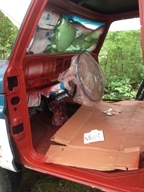 1971 Ford F-250 - The interior of a truck is shown with the dashboard and door frames painted red, ready for further work.