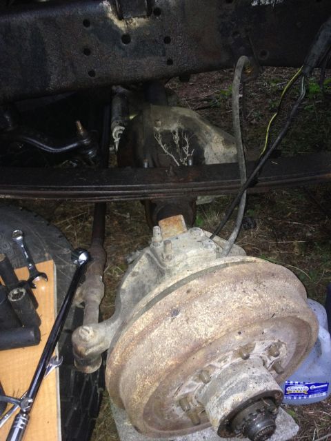 1971 Ford F-250 - This image shows the underside of a truck, focusing on the brake assembly and suspension system.