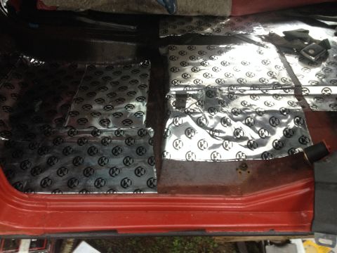 1971 Ford F-250 - Sound deadening material is installed on the floor of a red truck's interior.