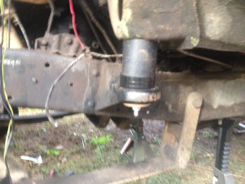 1971 Ford F-250 - Undercarriage view of a truck's frame and suspension system, supported by a jack stand.