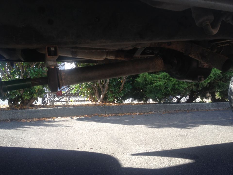 Undercarriage view of truck driveshaft and exhaust system