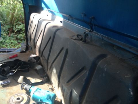 1971 Ford F-250 - Fuel tank and tools are visible inside a vehicle, suggesting a repair or replacement is underway.