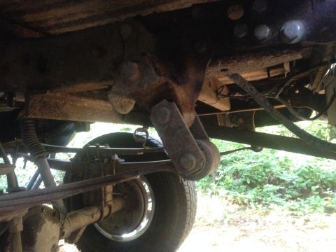 1971 Ford F-250 - Close-up of the rear suspension and drivetrain components of an older truck.