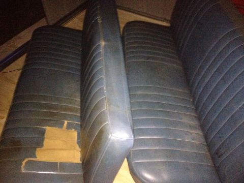 1971 Ford F-250 - Interior view of worn blue car seats with visible damage to the upholstery.