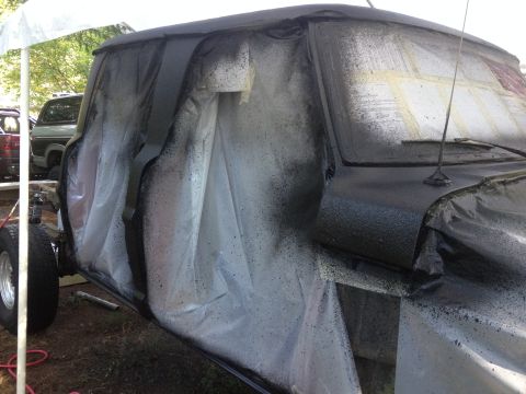 1971 Ford F-250 - Truck cab covered for spray painting, with a second vehicle in the background.