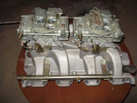 1963 Ford Galaxie - Dual carburetors and intake manifold assembly. Part number visible on the manifold.