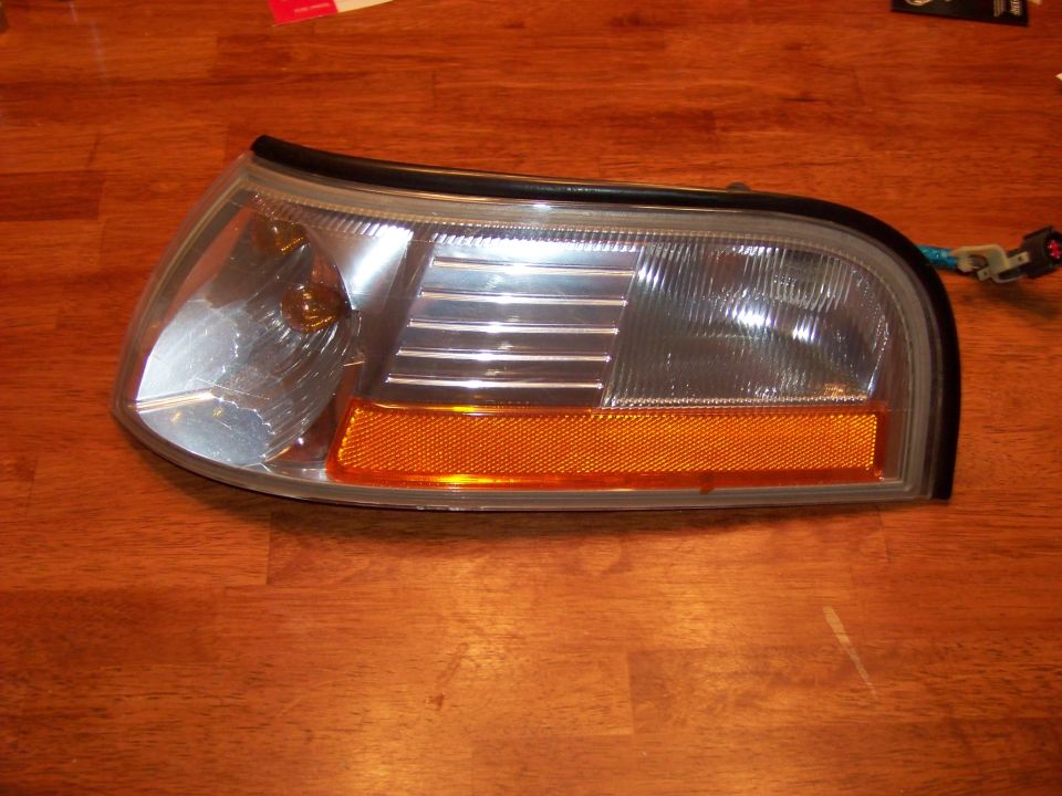 Headlight assembly with amber turn signal, sits on wood surface