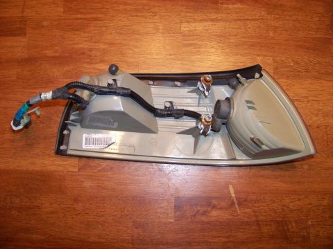 1995 Mercury Grand Marquis - A car tail light assembly is shown from the rear, with its wiring and bulb sockets visible.