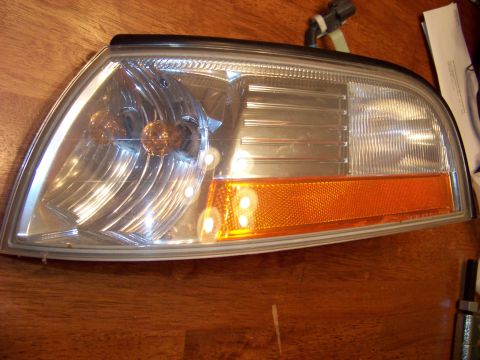 1995 Mercury Grand Marquis - Headlight assembly with amber turn signal, likely for a sedan.