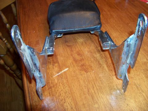 1995 Mercury Grand Marquis - This is a motorcycle backrest with chrome mounting hardware, shown on a wooden surface.