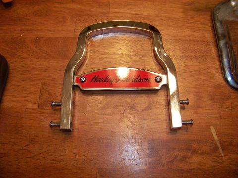 1995 Mercury Grand Marquis - A chrome luggage rack with a red Harley-Davidson emblem is shown on a wooden surface.