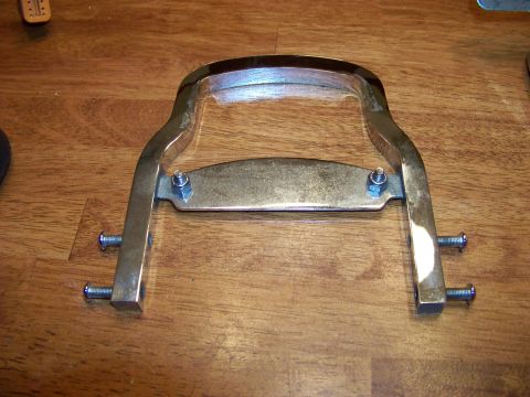 1995 Mercury Grand Marquis - Chrome luggage rack part with bolts on a wooden surface.