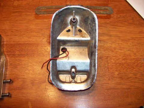 1995 Mercury Grand Marquis - Chrome tail light housing with exposed wiring, likely for an older vehicle.
