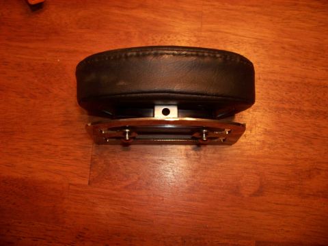 1995 Mercury Grand Marquis - A car part, possibly a seat component, rests on a wooden surface.