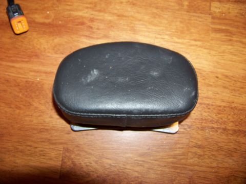 1995 Mercury Grand Marquis - A black leather headrest is shown on a wooden surface, with a Supermotors.net watermark in the lower right corner.