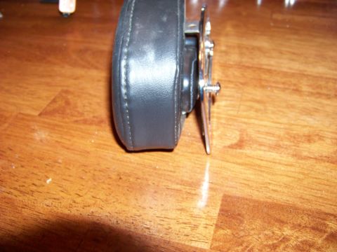 1995 Mercury Grand Marquis - A black leather steering wheel hub adapter is shown on a wooden surface. The registry claims it is for a 1995 Mercury Grand Marquis.