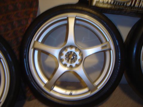1998 Ford Taurus - A single aftermarket car wheel is shown in detail, with a portion of another wheel visible to the right.
